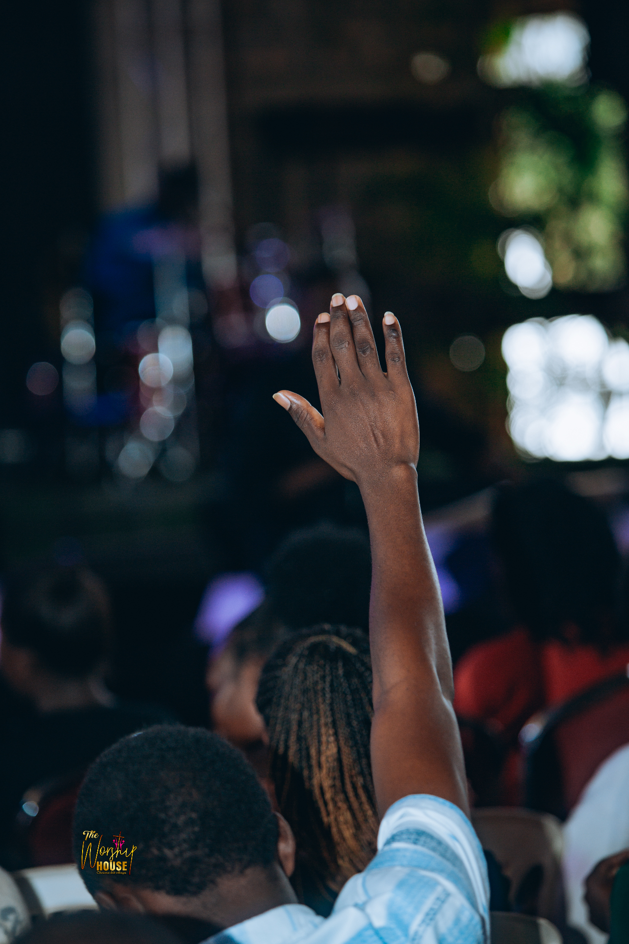 Person raising hand in worship